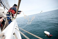 ATLANTIC OCEAN -- Coast Guard Cutter Eagle crew member Fireman Jesse Brown retrieves a "person in the water" during a man-overboard drill March 20, 2013. U.S. Coast Guard photo by Petty Officer 3rd Class Cory J. Mendenhall. Original public domain image from Flickr