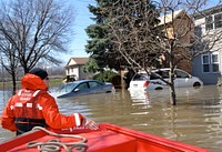U.S. Coast Guard Petty Officer 1st Class Todd George, assigned to a disaster assistance response team with Marine Safety Detachment Quad Cities, wades through a flooded area of Forest View, Ill., during rescue efforts April 20, 2013.