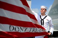 U.S. Navy Airman Justin Frisbie hoists the Navy jack on the flight deck of the aircraft carrier USS John C. Stennis (CVN 74) after the ship?s arrival in Pearl Harbor, Hawaii, April 21, 2013, for a scheduled port visit.