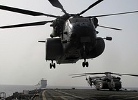 A U.S. Navy MH-53E Sea Dragon helicopter assigned to Helicopter Mine Countermeasures Squadron (HM) 15 takes off from the flight deck of the afloat forward staging base USS Ponce (AFSB(I) 15) as the Canadian dock landing ship RFA Cardigan Bay (L3009) operates in the background in the U.S. 5th Fleet area of responsibility May 15, 2013, during International Mine Countermeasures Exercise (IMCMEX) 13.