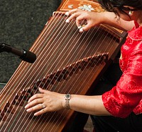 Washington Chinese Traditional Orchestra’s Huilan Chen gives a solo performance of “Gao Shan Liu shui” and “Yi zu Wu qu” on the Guzheng, an ancient type of musical instrument, during the U.S. Department of Agriculture (USDA) Asian Pacific American Heritage Month Observance, at the USDA headquarters, Whitten Building patio, in Washington, D.C., on Thursday, May 23, 2013.