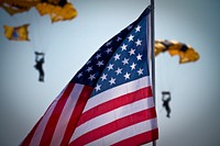 American flag with army paratroopers behind. Original public domain image from Flickr