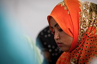 A woman listens during a meeting with United Nations Special Representative of the Secretary-General for Somalia (SRSG), Nicholas Kay where Somali women activists and representatives of women's groups spoke about their experiences and the challenges they face in protecting human rights, promoting women&rsquo;s political participation and addressing sexual and gender based violence in Somalia. Original public domain image from Flickr