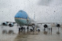 Air Force One is seen through rain drops on a Nighthawk 2 helicopter window at Joint Base McGuire-Dix-Lakehurst in New Jersey, May 28, 2013.