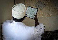 A delegate reads the Koran. Original public domain image from Flickr