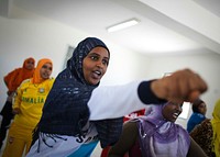 Female members of Mogadishu neighbourhood watch teams practise during a training programme designed by the African Union Mission in Somalia (AMISOM) to teach basic and practical self-defense skills to women, 11 September 2013.