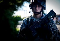 U.S. Air Force Senior Airman Sandra Welch, a combat photographer with the 1st Combat Camera Squadron, looks on during a simulated patrol at Joint Base Charleston's weapons station in South Carolina Oct. 4, 2013.