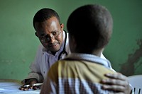 A doctor speaks to a young boy before examining him at a hospital run by Dr. Hawa in the Afgoye corridor of Somalia on September 25. Original public domain image from <a href="https://www.flickr.com/photos/au_unistphotostream/10439688096/" target="_blank">Flickr</a>