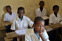 Students sit in a class at a school run by the Abdi Hawa Center in the Afgoye corridor of Somalia on September 25. Original public domain image from <a href="https://www.flickr.com/photos/au_unistphotostream/10439743763/" target="_blank">Flickr</a>