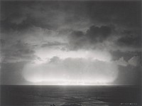 A nuclear detonation during the 1951 spring tests at Eniwetok Atoll is shown with smoke trails from rockets designed to capture sample materials. Original public domain image from Flickr