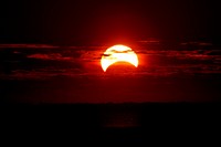 Sunrise during partial solar eclipse. Original public domain image from Flickr
