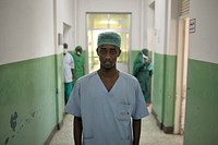 A surgeon stands in the hallway of Banadir hospital in Mogadishu, Somalia, on February 4. AU UN IST PHOTO / Tobin Jones. Original public domain image from Flickr