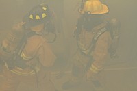 U.S. Air Force fire protection specialists from the New Jersey Air National Guard's 177th Fighter Wing perform a search in a smoke-filled room during a simulated rescue at the Federal Air Marshal Training Center shoot house on March 11, 2014.