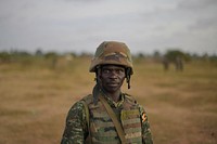 An African Union soldier stands guard at a base in Janaale, Somalia, on March 21 ahead of a planned offensive by the African Union Mission in Somalia on the nearby town of Qoryooley. AU UN IST PHOTO / Tobin Jones. Original public domain image from Flickr