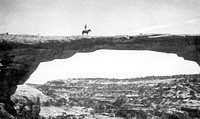 Natural Bridges National Monument in Utah. Dan Perkins standing on his horse "Cap" on top of Owachomo Bridge. Original public domain image from Flickr