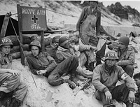 "Navy Aid Station." (D-day) Corpsmen await business on a French invasion beach. 2nd Naval Beach Battallion, Utah Beach. [Soldiers.] [World War 2. European Theater.] [Scene.] WWII (European Theater). BuAer 252749. Original public domain image from Flickr