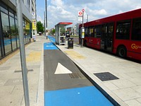A "level access" wheelchair compatible crossing point of Cycle Superhighway2 at one of the island bus stops which avoid conflict between cyclists and the buses that stop here - Stratford High Street, Stratford, London.