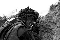 Adazi Training Area, LATVIA – An Estonian Soldier shouts orders to his teammates during a movement to contact situational training exercise lane here, June 13, 2014. 