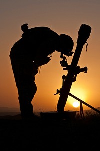 U.S. Army Spc. Zac Moore, a mortarman with Mortar Platoon, 2nd Battalion, 504th Parachute Infantry Regiment, 82nd Airborne Division, sights in an 81 mm mortar tube at an observation post overlooking the Darwazgay Pass in Zabul province, Afghanistan, June 23, 2014.