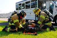 Georgetown County Fire/EMS first responders secure a simulated victim onto a stretcher during a bus crash scenario at a local company in Georgetown, S.C., June 5, 2014.