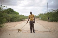 A member of the Somali National Army and his pet monkey stand in the middle of Bulo Burte's main road in Somalia on August 12.