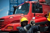A fireman checks on a front hose of a firetruck during a handover of 8 fire trucks by UNSOA to the Federal Government of Somalia on 29th August 2014 at Mogadishu Log Base. The trucks are to be used in Mogadishu, Kismayo, Baidoa, Belet weyne and Bela dogle.