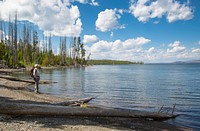 Visitor enjoying the western shorline of southeast arm of Yellowstone Lake by Neal Herbert. Original public domain image from Flickr