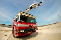 U.S. Air Force Staff Sgt. Albert Siu sits in a fire truck on the flight line at Atlantic City Air National Guard Base, N.J. on Sept. 23, 2014. Siu is a fire supression specialist with the 177th Civil Engineering Squadron. Original public domain image from Flickr