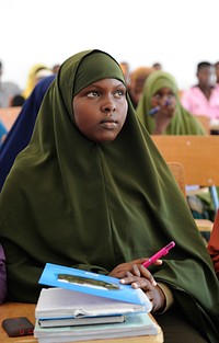 A student listens to her teacher in class at the Somali National University in the capital Mogadishu on October 23rd, 2014. Original public domain image from <a href="https://www.flickr.com/photos/au_unistphotostream/15428342489/" target="_blank">Flickr</a>