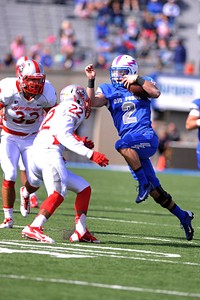 Kale Pearson, No. 2, a quarterback with the U.S. Air Force Academy Falcons, tries to avoid Markel Byrd, No. 22, a defensive back with the University of New Mexico Lobos, during a football game at Falcon Stadium in Colorado Springs, Colo., Oct. 18, 2014.