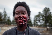 A civilian actor dressed in moulage to simulate an injury stands by to be placed at an accident site during a full scale exercise involving over 600 Army and Air National Guardsmen from New York, New Jersey, and West Virginia at Joint Base McGuire-Dix-Lakehurst, N.J., April 17, 2015.