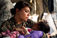 U.S. Navy Hospital Corpsman 2nd Class Jessica Gomez, from Carey, Idaho, cares for an injured child in a triage at the Tribhuvan International Airport in Kathmandu, Nepal, May 12.
