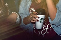 Starbucks plastic cup in woman's hand, location unknown, 25/05/2015