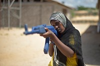 Young Somali women, training to become Military Police, train with plastic weapons in order to learn how to shoot correctly at Jazeera Camp in Mogadishu, Somalia, on May 16. AMISOM Photo / Tobin Jones. Original public domain image from Flickr