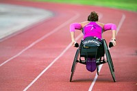 Army Capt. Kelly Elminger does laps in her race wheelchair at Joint Base San Antonio June 11, 2015 while training for the 2015 Department of Defense Warrior Games. Elminger survived a rare form of cancer that damaged her lower left leg. Original public domain image from Flickr