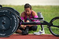 Army Capt. Kelly Elminger prepares her stocking for her lower-leg prosthetic at Joint Base San Antonio June 11, 2015 while training for the 2015 Department of Defense Warrior Games. Original public domain image from Flickr