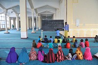 Somali children take lessons on the Quran at a Madrasa in Isbahaysiga mosque on June 16, 2015 as muslims prepare for the fasting month of Ramadan, the holiest month in the Islamic calendar.AMISOM Photo/Omar Abdisalan. Original public domain image from <a href="https://www.flickr.com/photos/au_unistphotostream/18704259928/" target="_blank" rel="noopener noreferrer nofollow">Flickr</a>
