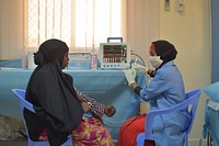 A staff member of the Sheikh Zayed Bin Sultan Al'Nahya Hospital takes the vital signs of a patient in Mogadishu, Somalia, on August 6. In an effort to streamline the medical care given to all of the patients who go through the hospital, the vital signs of all patients are taken first before the patients are seen by a doctor.