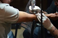 Getting a tattoo. Free public domain CC0 photo.