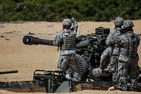 Soldiers from the New Jersey Army National Guard's 3-112th Field Artillery live-fire M119A3 Howitzers at Joint Base McGuire-Dix-Lakehurst, N.J., Aug. 26, 2015. (U.S. Air National Guard photo by Tech. Sgt. Matt Hecht/Released). Original public domain image from Flickr