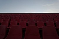 Red chairs at stadium, background photo. Free public domain CC0 image.