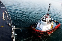 151023-N-AX546-019 BATUMI, Georgia (Oct. 23, 2015) A Georgian tug boat pulls USS Porter (DDG 78) off the pier Oct. 23, 2015.