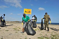 Staff of the United Nations in Somalia collect garbage during a clean-up exercise of the seashore in Mogadishu, Somalia. The exercise was part of activities to mark the 70th anniversary of the UN on October 24, 2015. UN Photo/ Omar Abdisalan. Original public domain image from Flickr