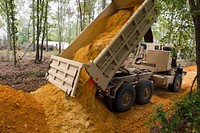 U.S. Soldiers with the 124th Engineer Company, South Carolina Army National Guard, haul clay dirt to rebuild roads that were washed out in Swansea, S.C., as the state recovers from last week’s flooding, Oct. 13, 2015.