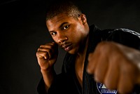 U.S. Air Force Staff Sgt. Leon Jackson, a structural maintenance specialist with the New Jersey Air National Guard's 108th Wing, poses for a portrait in his gi, the traditional garb he wears as a Brazilan jiu-jitsu purple belt, on Nov. 23 at Joint Base McGuire-Dix-Lakehurst.