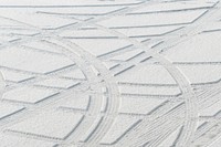 Tire tracks in new snow at a parking lot. Free public domain CC0 photo.