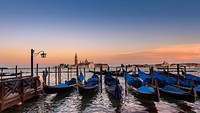 A row of gondolas in water. Free public domain CC0 photo.