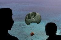 Royal Australian Air Force Sergeant Karl Penny, a loadmaster with the 37th Squadron, left, and Corporal Liz Knauer, a supply technician with the 37th Squadron, watch as the parachute of a bundle opens up as it goes toward a Micronesian island during the 66th Operation Christmas Drop, Dec. 10, 2017.