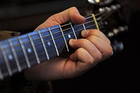 “Healing America’s Heroes through the Power of the Arts” Detail shot D chord on the fret board as Marine Staff Sgt. Anthony Mannino plays guitar as he receives Music Therapy as part of his Traumatic Brain Injury (TBI) treatment and recovery.