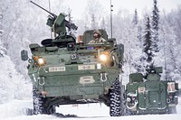 One crew of Soldiers assigned to the 1st Battalion, 5th Infantry Regiment, 1st Stryker Brigade Combat Team, 25th Infantry Division, U.S. Army Alaska, maneuvers into position to enter the range for gunnery on Joint Base Elmendorf-Richardson, Alaska, during Operation Punch Bowl as another leaves after finishing firing. The Fort Wainwright based Soldiers' operation culminated with multiple live-fire and combat training events. (U.S. Air Force photo/Justin Connaher). Original public domain image from Flickr